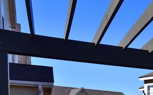 Light blue cushions cover our wicker pool furniture beneath an open air pergola at Summit Pointe in Oklahoma City, OK