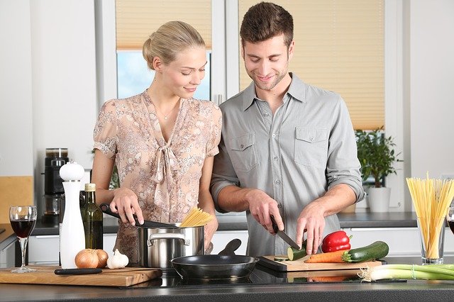 men and woman cooking at home