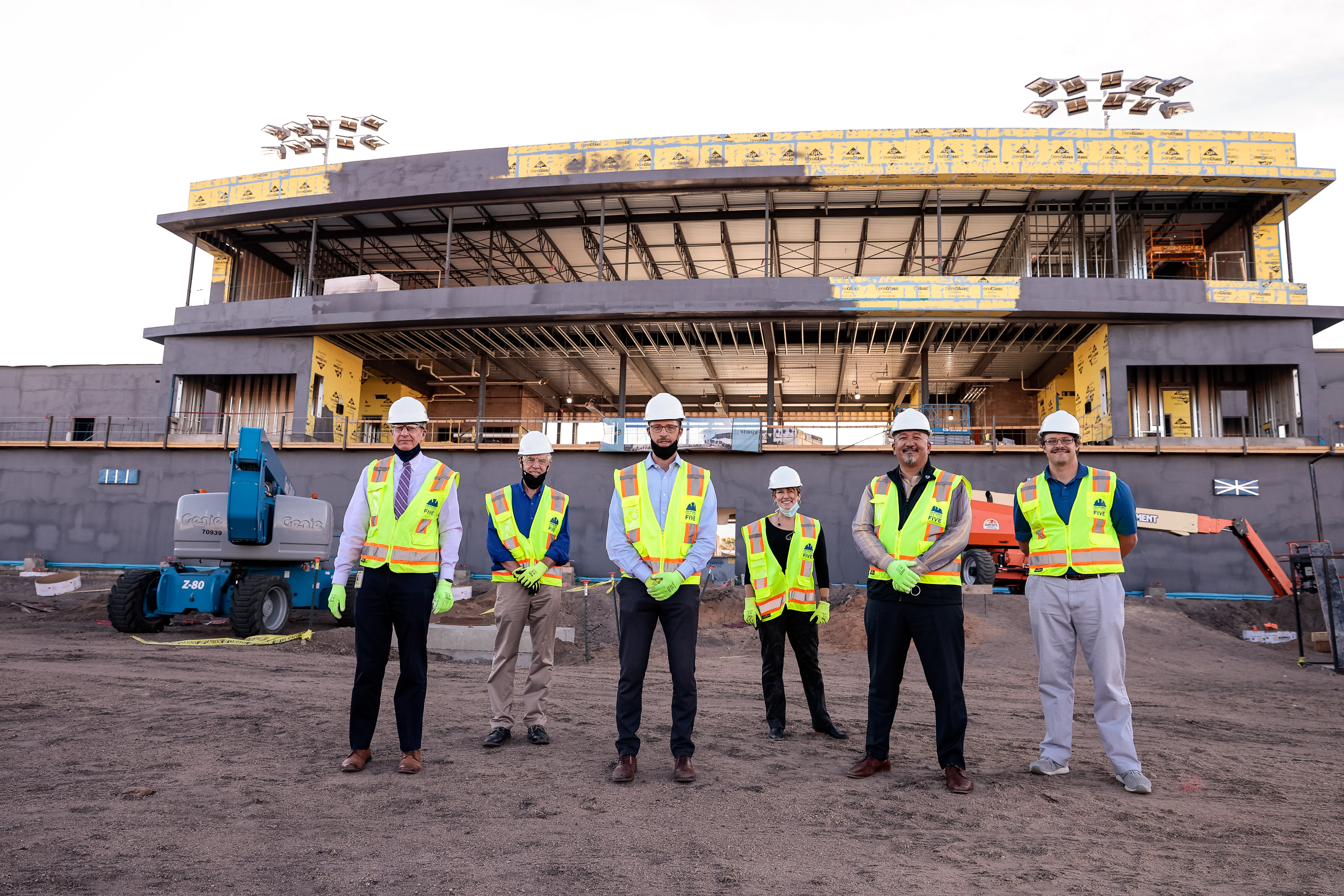 Members of Weidner Apartment Homes and the Colorado Switchback FC staff at Weidner Field during the burial of the community time capsule.