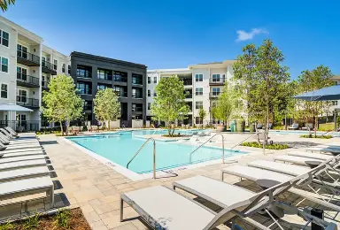 Apartment complex outdoor swimming pool with lounge chairs
