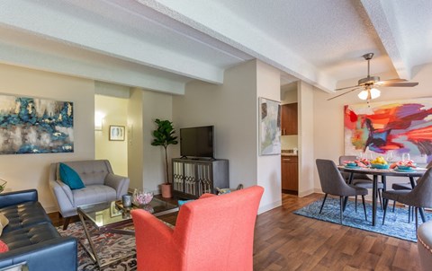 A living room with a red chair and a television.