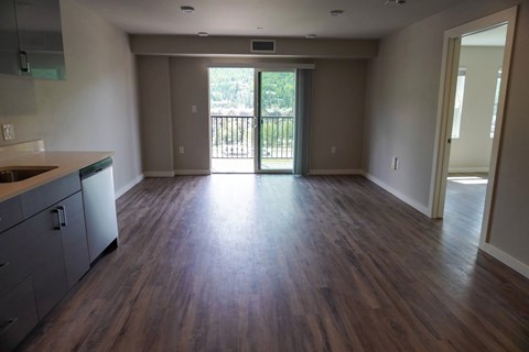 A kitchen with a dining table and chairs is visible.