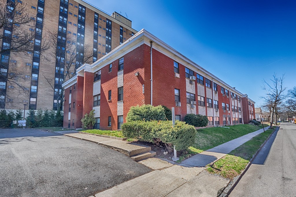 a large brick building with a street in front of it