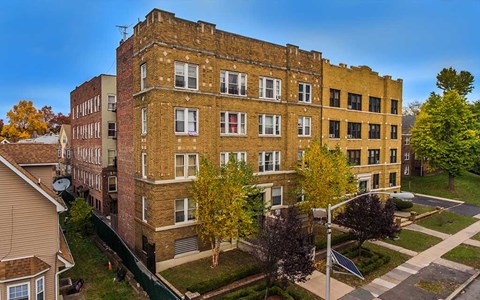 an aerial view of an old brick building on a city street