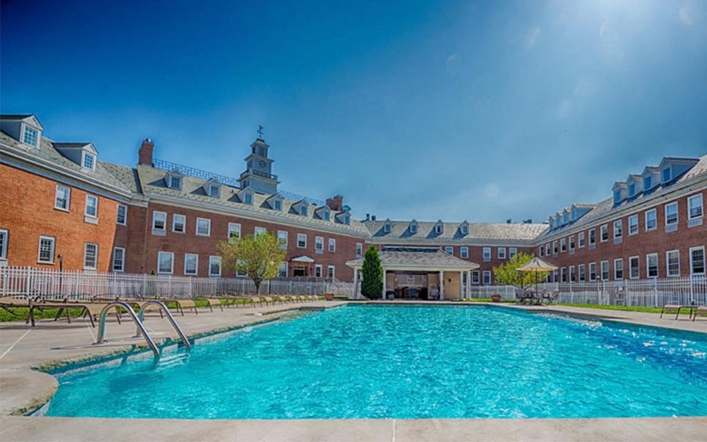 a swimming pool with a building in the background