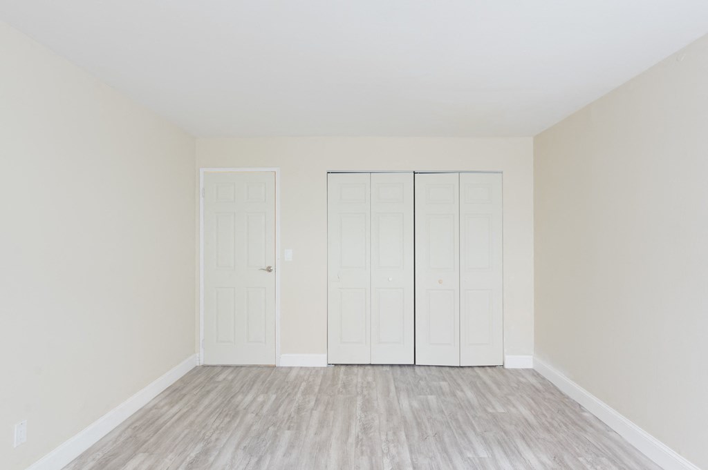 an empty room with white walls and white doors