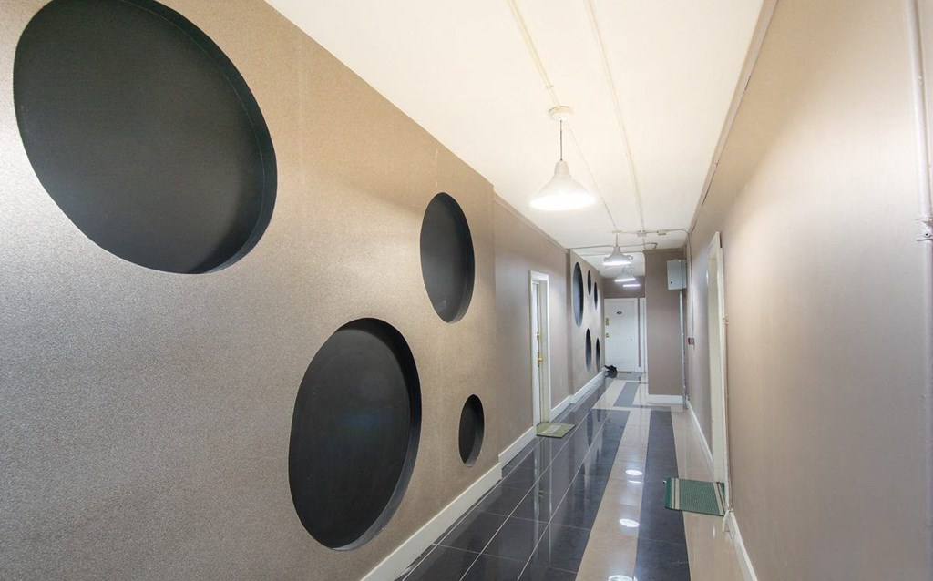 a hallway with circles on the wall in a building