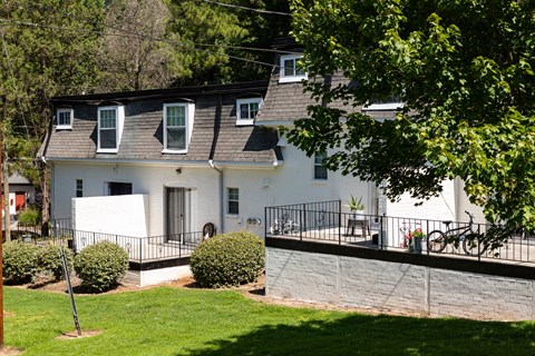 a white house with a deck and a yard