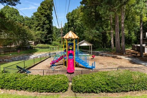 a playground with a colorful swing set in a park