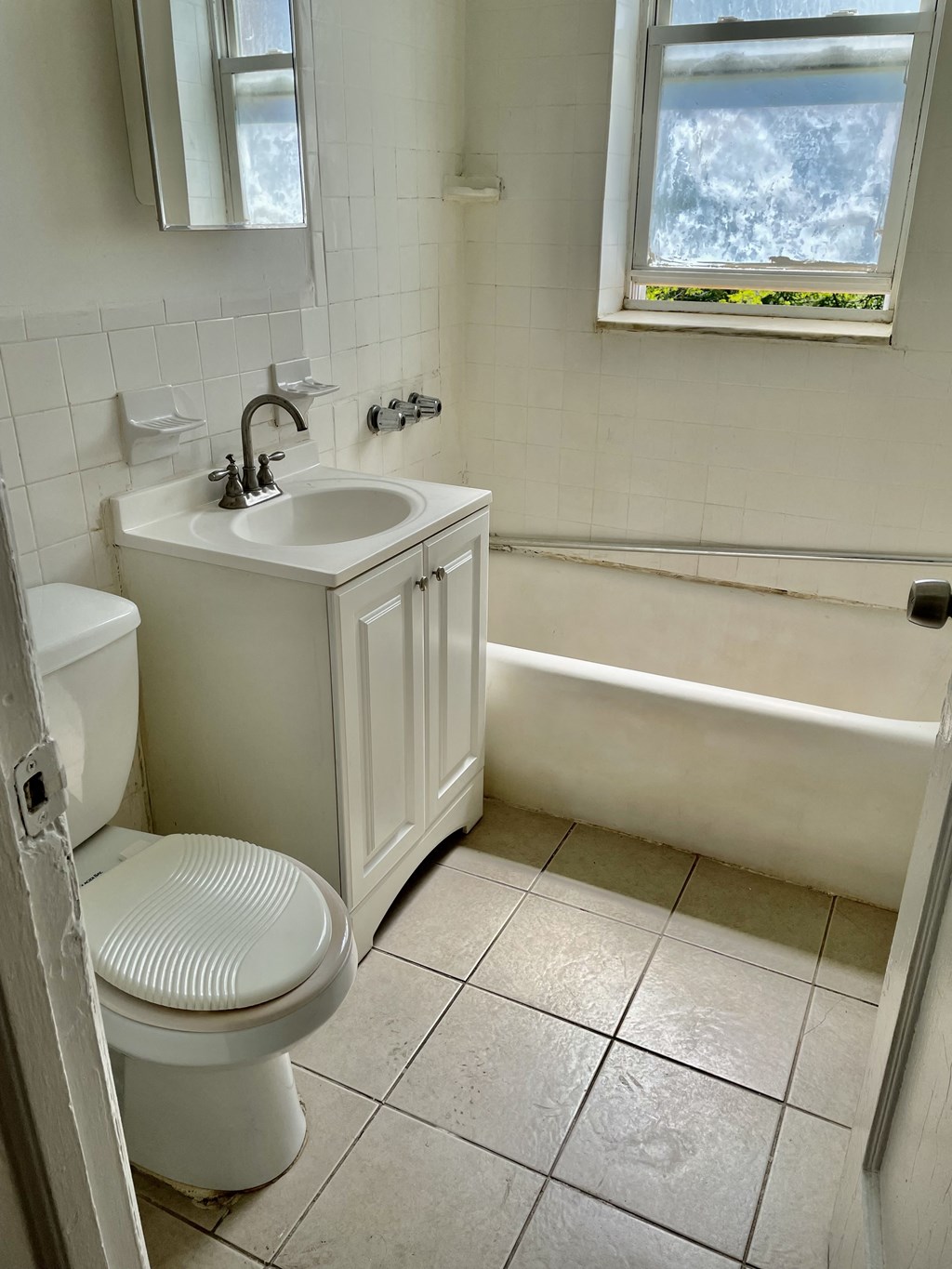 a bathroom with a sink toilet and a bath tub
