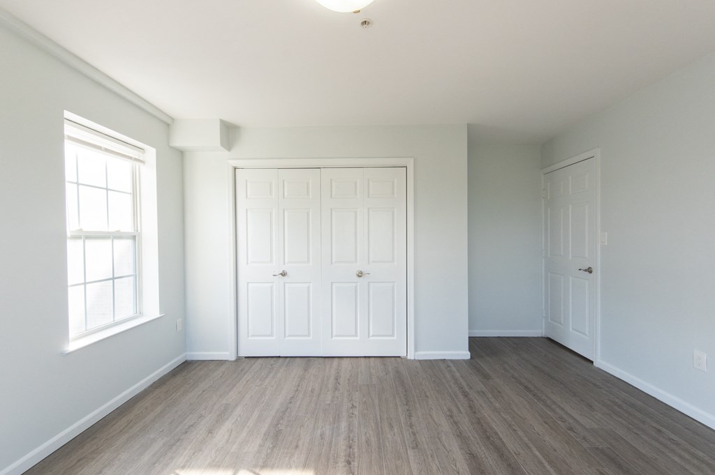 an empty room with white walls and white doors