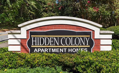 a sign for hidden colony apartment homes