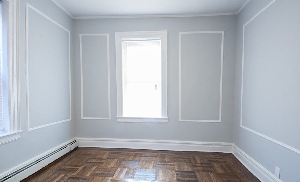 a empty room with white walls and a window