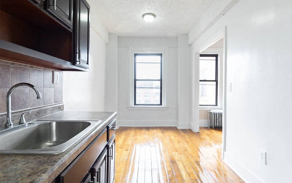 an empty kitchen with a sink and a window