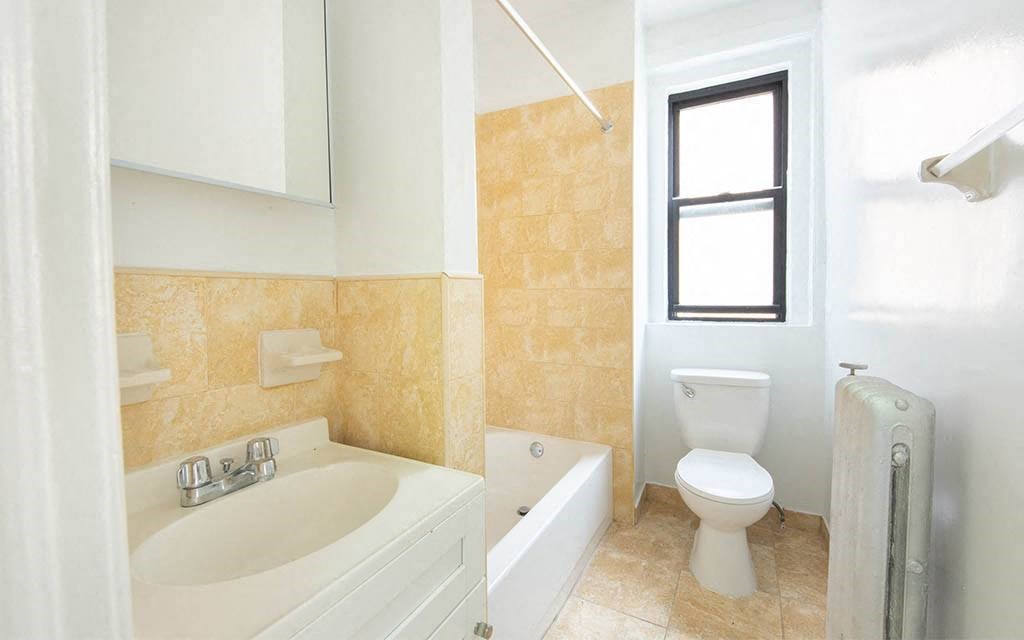 a bathroom with a sink toilet and a tub