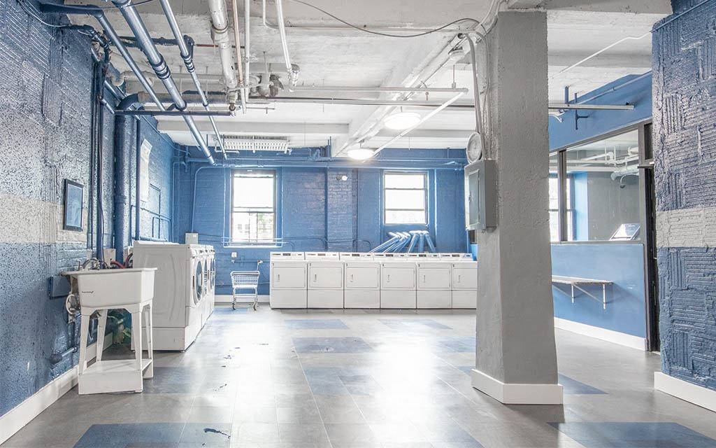 a large room with blue walls and white cabinets