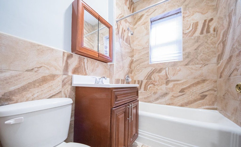 a bathroom with a toilet and a sink and a bath tub