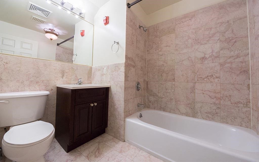 a bathroom with a toilet and a tub and a sink