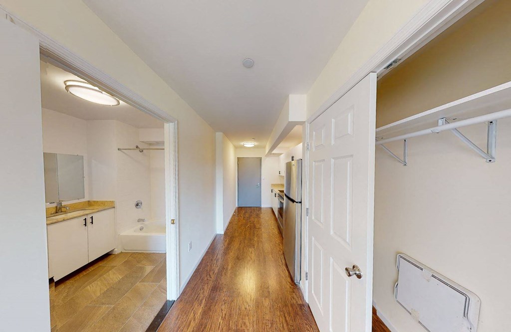 a renovated hallway with a door to a bathroom and a laundry room