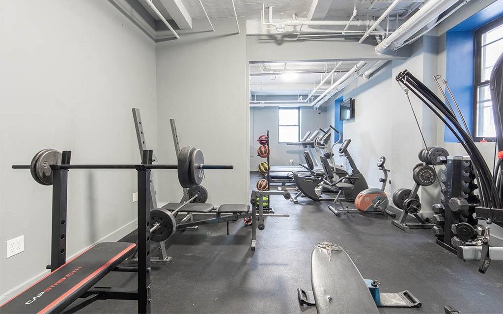 a gym with various exercise equipment in it