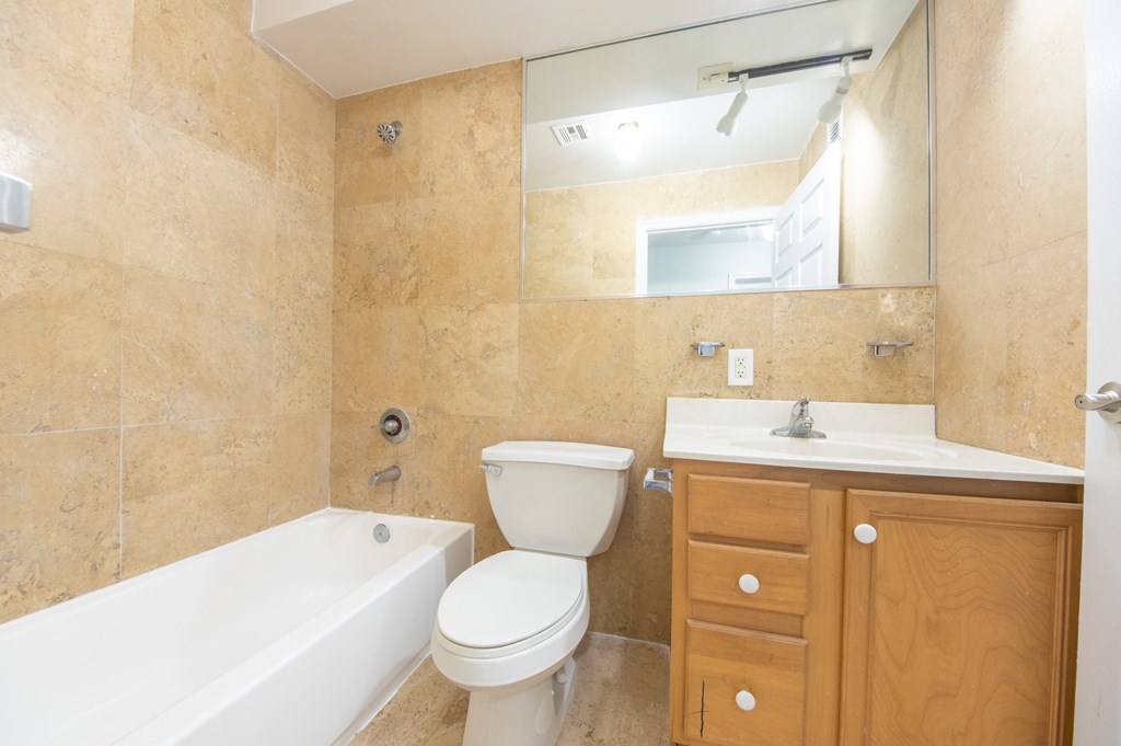 a bathroom with a sink toilet and a tub