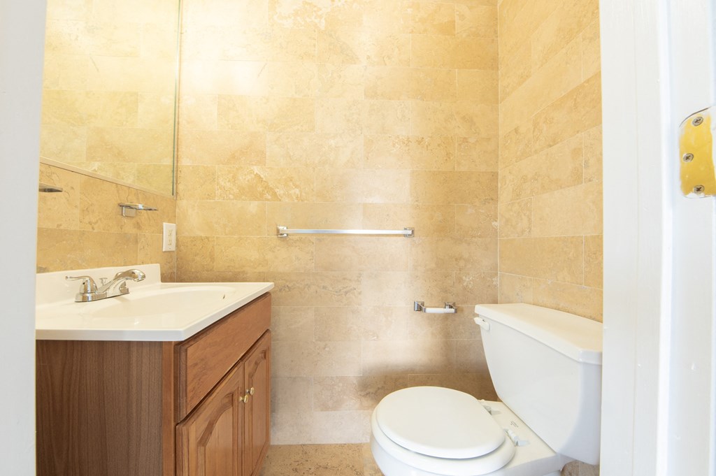 a bathroom with a toilet sink and a mirror