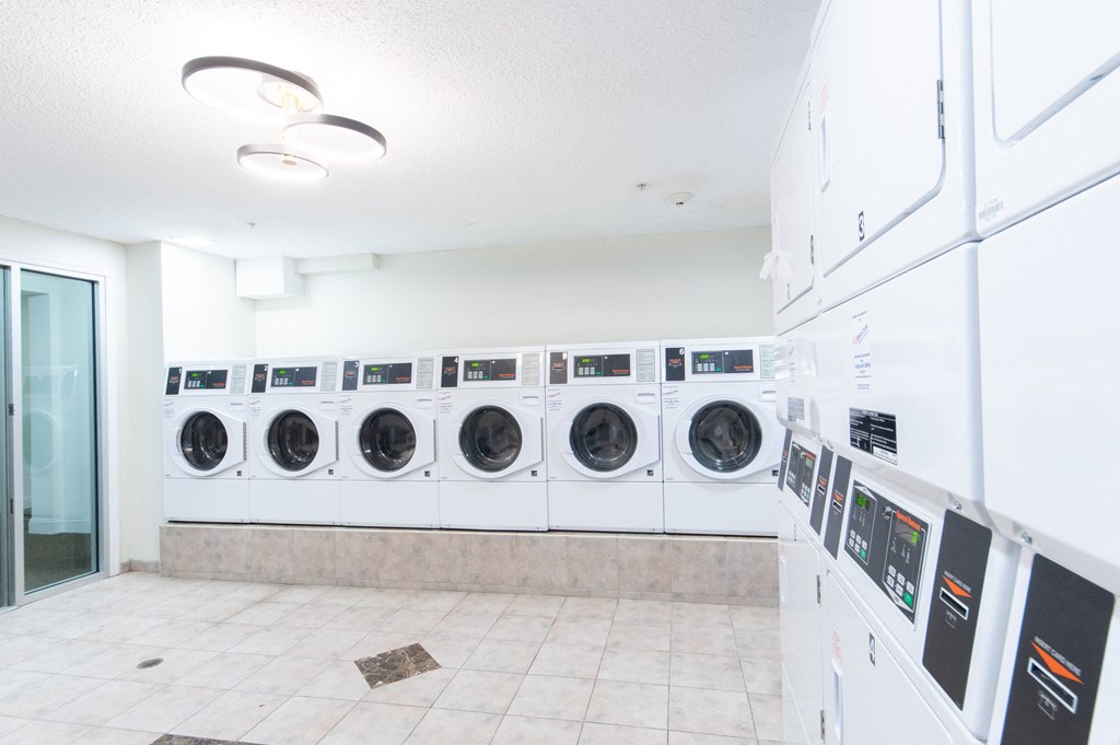 a washer and dryer laundry room with a row of washing machines