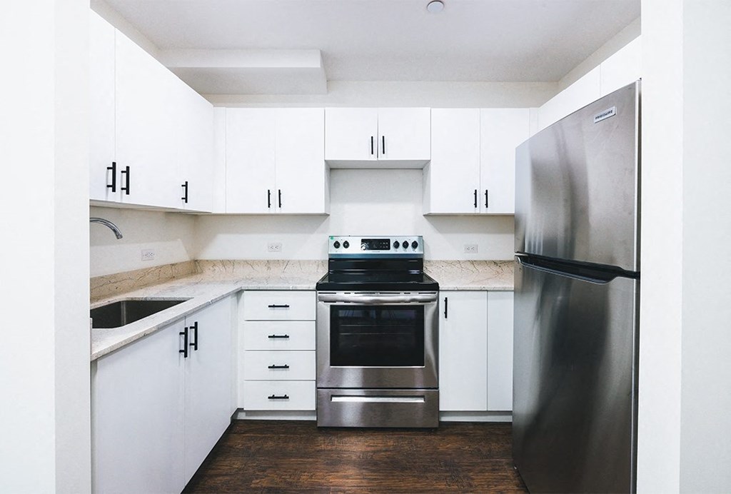 a kitchen with white cabinets and stainless steel appliances