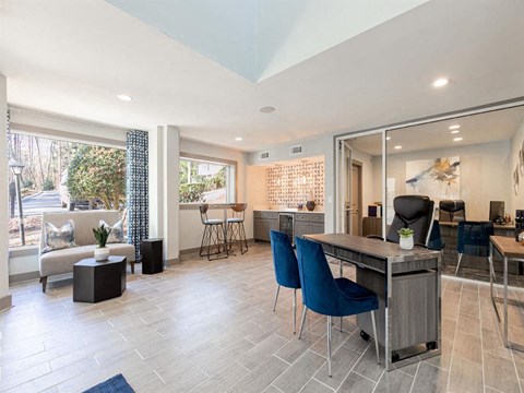 a kitchen and living room with a table and chairs