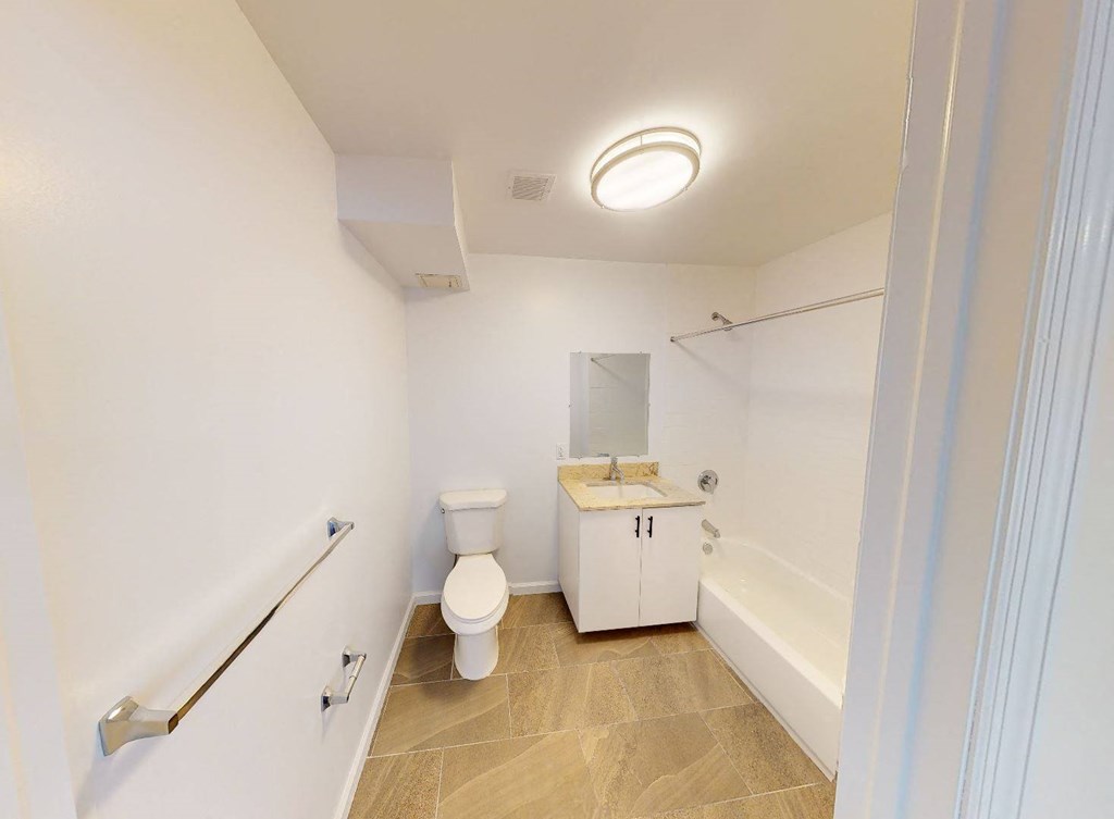 a bathroom with a toilet and a tub and a sink