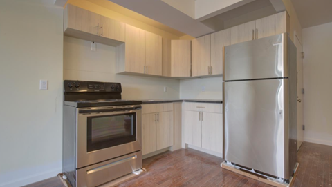 A kitchen with a stainless steel refrigerator and oven.