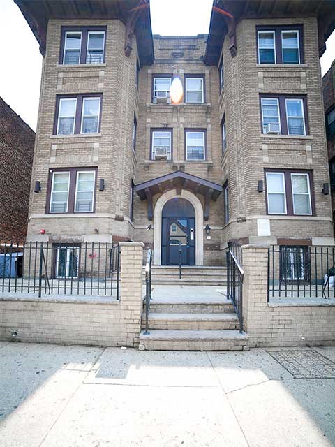 a large brick building with steps in front of it