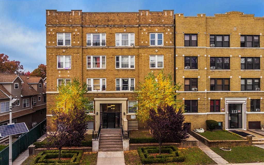 a large brick building with trees in front of it