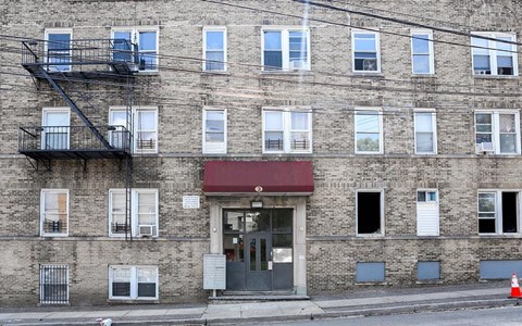 A building with a red awning and a fire escape.
