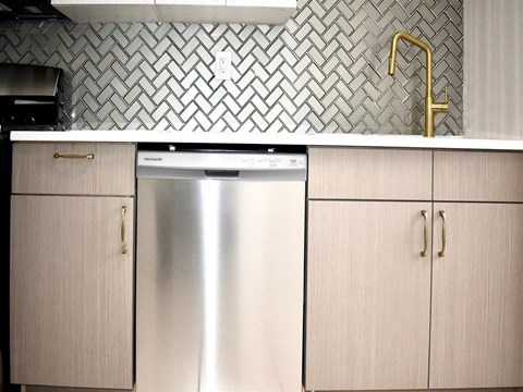 a kitchen with a stainless steel dishwasher