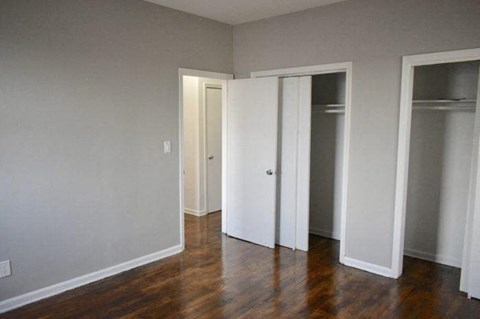 a living room with a wood floor and three doors