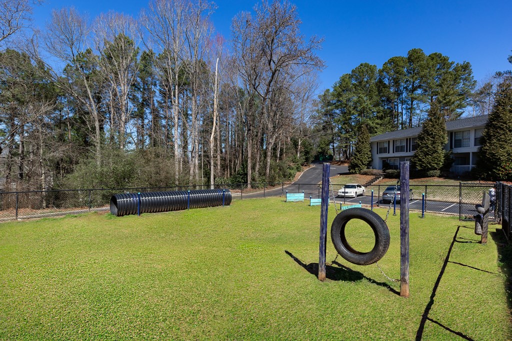 a park with a playground and trees in the background