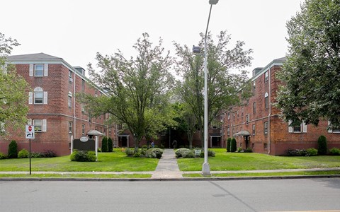 a sidewalk in front of a red brick building