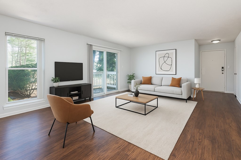 A living room with a brown chair and a white couch.