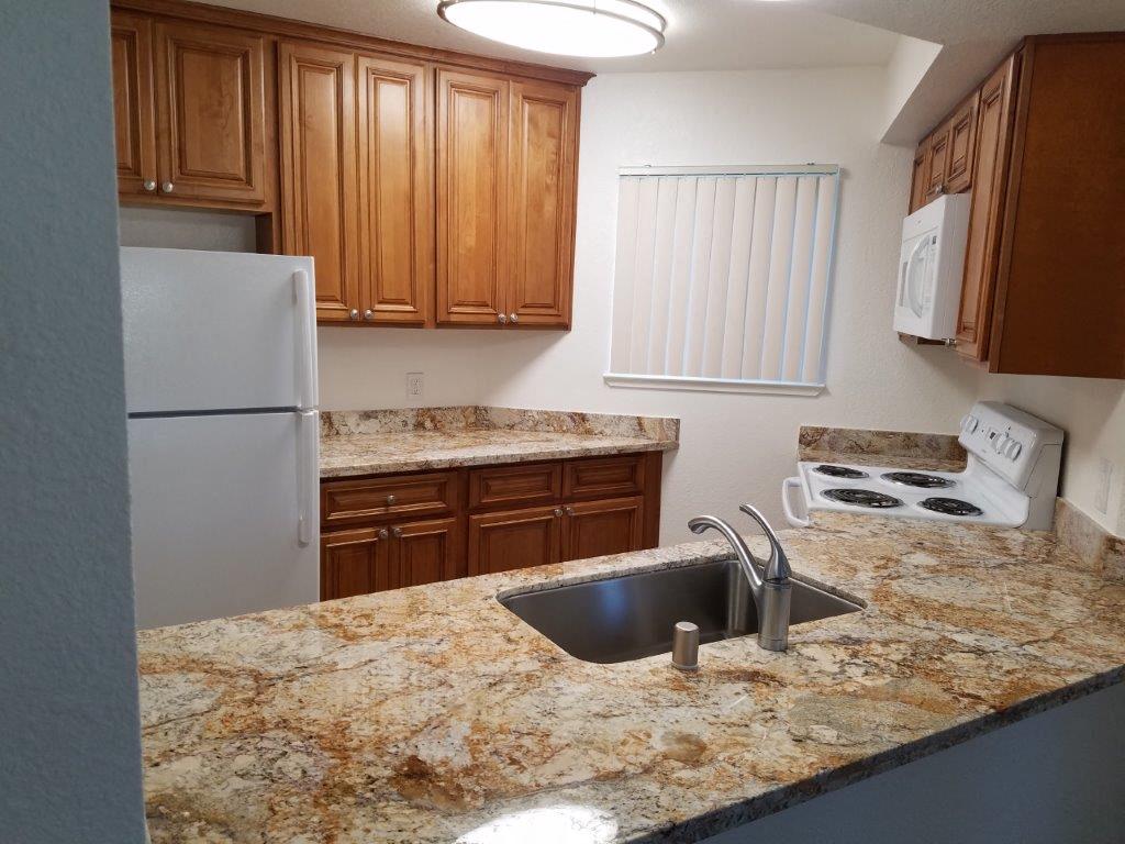 a kitchen with a sink and a refrigerator