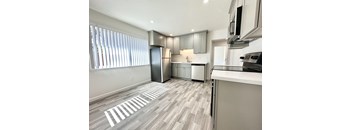 a kitchen with gray cabinets and a white counter top