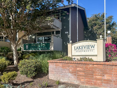 A sign for Lakeview Apartments is displayed in front of a building.