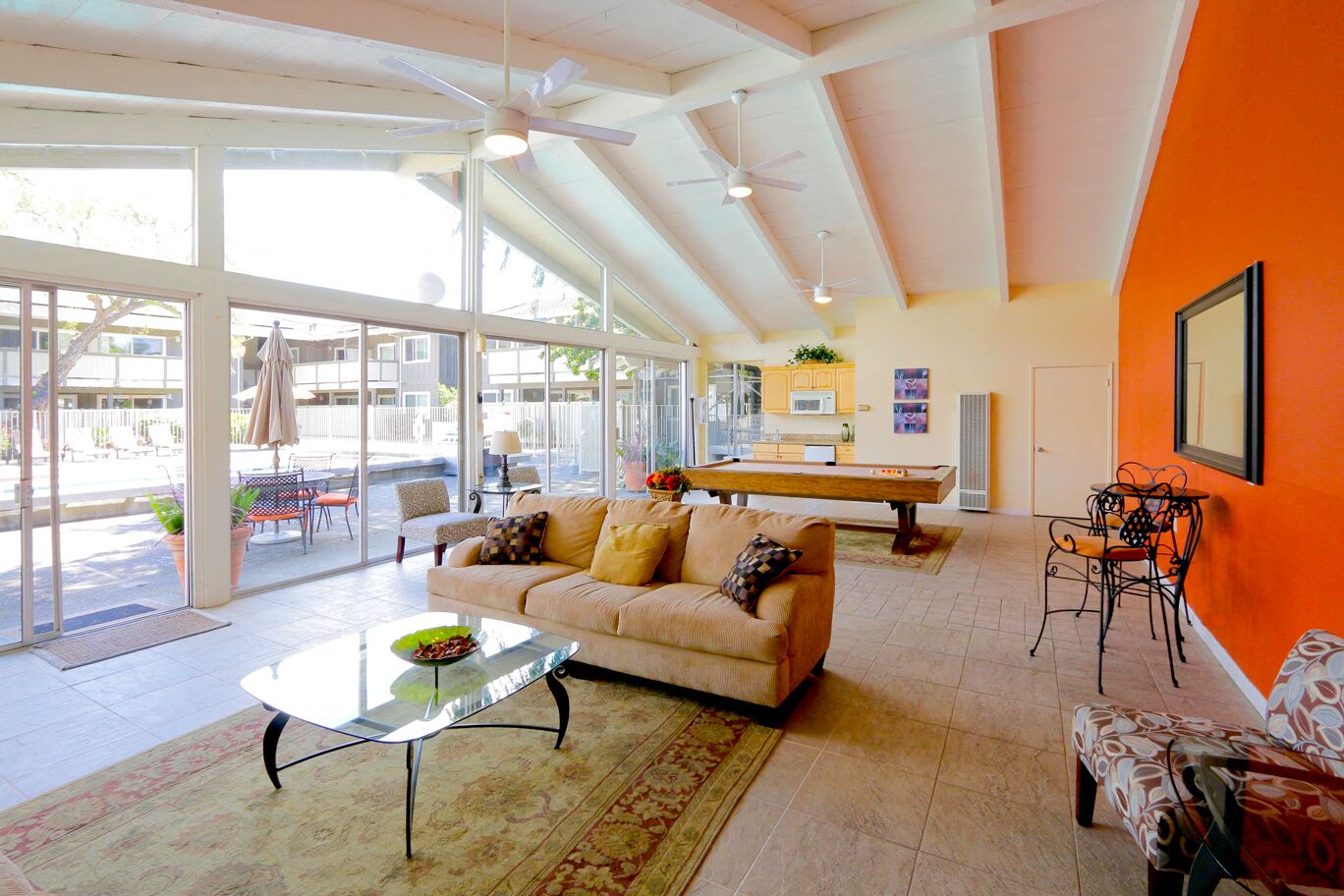 a living room with a couch and a pool table