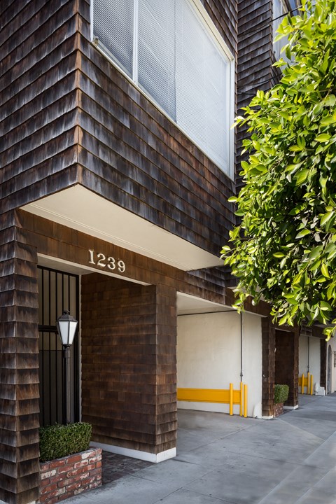 a brick building with a sidewalk in front of it