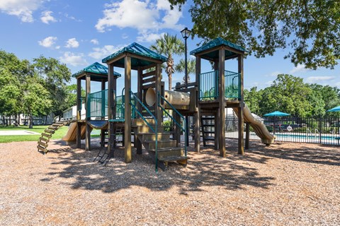A playground with a wooden structure and a slide.