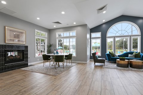 A modern living room with a fireplace and a dining table set up.