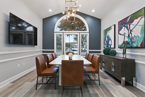 A dining room with a table and chairs.