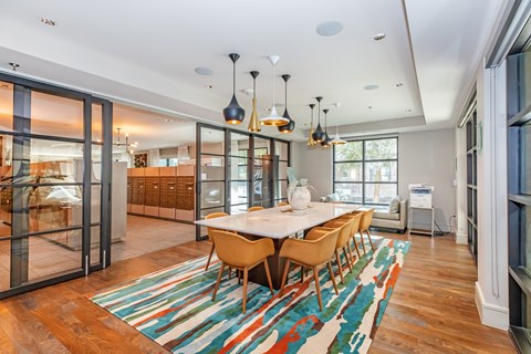 A dining room with a white table and chairs.