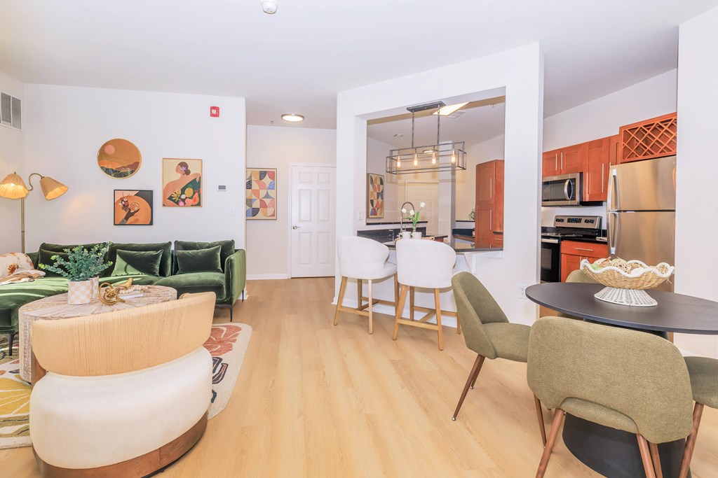 A living room with a green couch and a wooden coffee table.