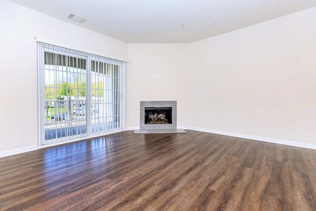 A room with a fireplace and sliding glass doors.